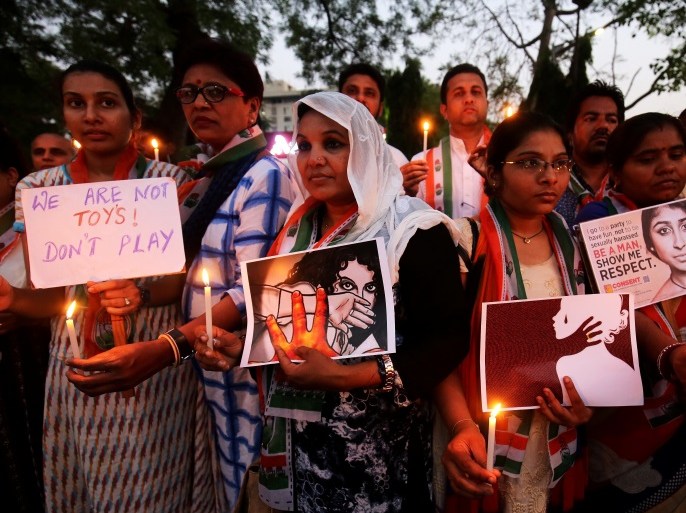 Supporters of India's main opposition Congress party participate in a candle light vigil as they protest against the rape of an eight-year-old girl in Kathua near Jammu, and a teenager in Unnao, Uttar Pradesh state, in Ahmedabad, India April 13, 2018. REUTERS/Amit Dave
