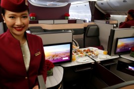 A Qatar Airways crew member presents the business class seats of an Boeing 777 aircraft during the 52nd Paris Air Show at Le Bourget airport near Paris, France, June 19, 2017. REUTERS/Pascal Rossignol
