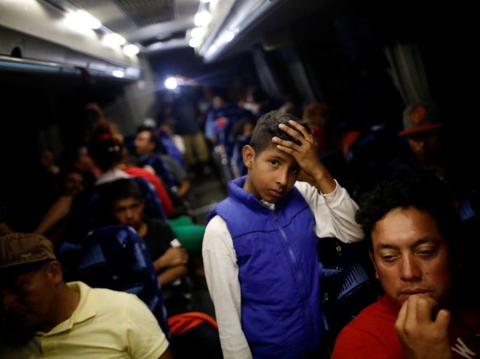 A Central American boy migrant, moving in a caravan through Mexico and traveling to request asylum in U.S., gestures inside a bus before his travels from Hermosillo to Mexicali, in Sonora state, Mexico April 23, 2018. REUTERS/Edgard Garrido