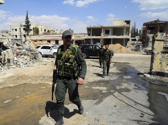 epa06672057 A handout photo made available by the official Syrian Arab News Agency (SANA) shows Syrian policemen patrol in Douma city in the eastern Ghouta in rural Damascus, Syria 15 April 2018. According to SANA, Douma is seing active movement in the streets and the gradual return of craftsmen and shops. EPA-EFE/SANA HANDOUT HANDOUT EDITORIAL USE ONLY/NO SALES