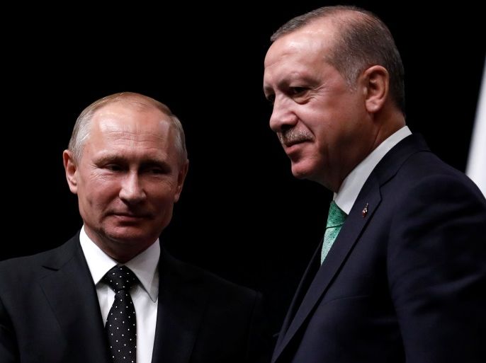 Turkish President Tayyip Erdogan poses with Russian President Vladimir Putin after a news conference in Ankara, Turkey, December 11, 2017. REUTERS/Umit Bektas