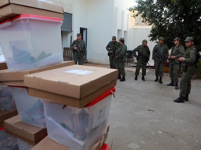 epa04499691 Tunisian soldiers stand guard near ballot boxes ahead of distributing them to polling centers for the presidential elections, in the governorate of Baja northwest of Tunis, Tunisia, 22 November 2014. Tunisian Prime Minister Mehdi Jomaa paid a working visit and inspection in the city of Beja on 22 November, in order to check the preparations mainly on the security plan to ensure the smooth running of the electoral process that will be held on 23 November. EPA