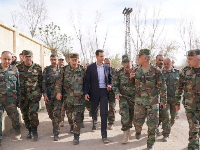 Syrian President Bashar al-Assad walks with Syrian army soldiers in eastern Ghouta, Syria, March 18, 2018. SANA/Handout via REUTERS ATTENTION EDITORS - THIS IMAGE HAS BEEN SUPPLIED BY A THIRD PARTY. REUTERS IS UNABLE TO INDEPENDENTLY VERIFY THIS IMAGE.
