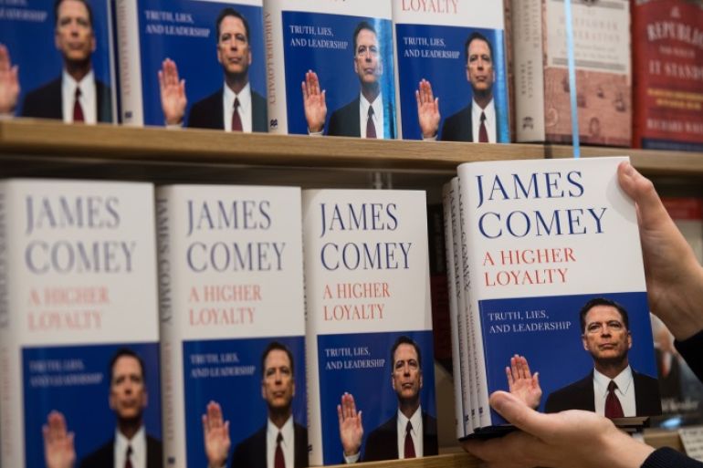 LONDON, ENGLAND - APRIL 17: In this photo illustration a Waterstone's employee places copies of Former FBI Director James Comey's book on a shelf as it is released in the UK at Waterstone's, Piccadilly on April 17, 2018 in London, England. The former Federal Bureau of Investigations Director was fired by US President Donald Trump in 2017 and has since written his book 'A Higher Loyalty' about everything from his childhood to his time as FBI Director and his firing by the president. (Photo illustration by Chris J Ratcliffe/Getty Images)