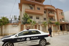 A police vehicle is seen parked in front of the Tunisian consulate in Tripoli, Libya June 13, 2015. An armed group stormed the Tunisian consulate in the Libyan capital Tripoli and kidnapped 10 staff on Friday, the Tunisian Foreign Ministry said. The ministry did not identify the armed group, but called the assault a