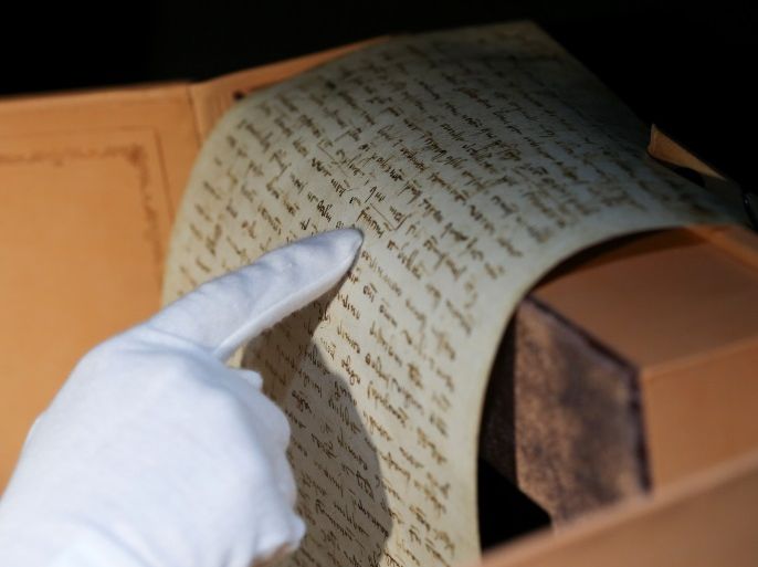 Rosi Fontana, spokeswoman for the Scrinium publishing house, points to an papyrus, a part of the exact replica of Marco PoloÕs 700-year-old last will and testament, in Rome, Italy, April 10, 2018. Picture taken April 10, 2018. REUTERS/Alessandro Bianchi