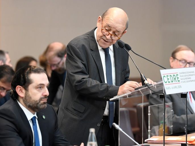 French Foreign Minister Jean-Yves Le Drian delivers his opening speech as Lebanese Prime Minister Saad Hariri (L) listens to during the Cedar (CEDRE) Conference for international donors and investors to support Lebanon's economy, in Paris, France, April 6, 2018. Eric Feferberg/Pool via Reuters