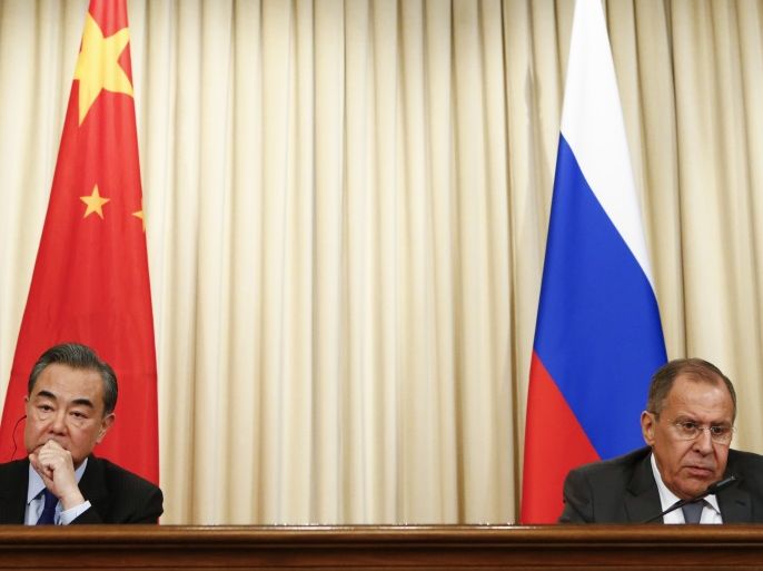 Russia's Foreign Minister Sergei Lavrov (R) and China’s top diplomat State Councillor Wang Yi attend a news conference after the talks in Moscow, Russia April 5, 2018. REUTERS/Sergei Karpukhin