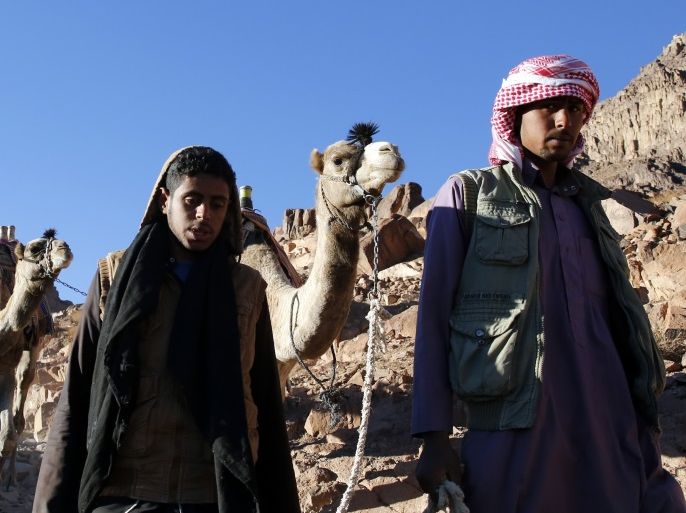 Bedouin mountain guides make their way down from the summit of Mount Moses, near the city of Saint Catherine, in the Sinai Peninsula, south of Egypt, December 9, 2015. According to the Bible, the mountain is where Moses received the ten commandments from God. Picture taken December 9, 2015. REUTERS/Amr Abdallah Dalsh