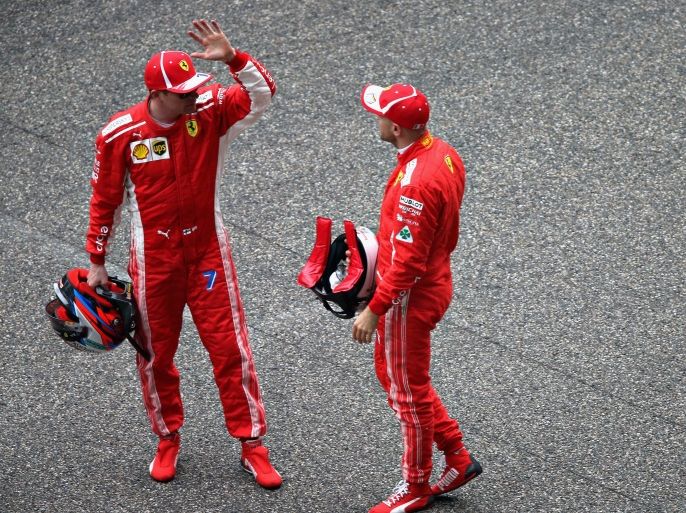 SHANGHAI, CHINA - APRIL 14: Top two qualifiers Sebastian Vettel of Germany and Ferrari and Kimi Raikkonen of Finland and Ferrari talk in parc ferme during qualifying for the Formula One Grand Prix of China at Shanghai International Circuit on April 14, 2018 in Shanghai, China. (Photo by Charles Coates/Getty Images)