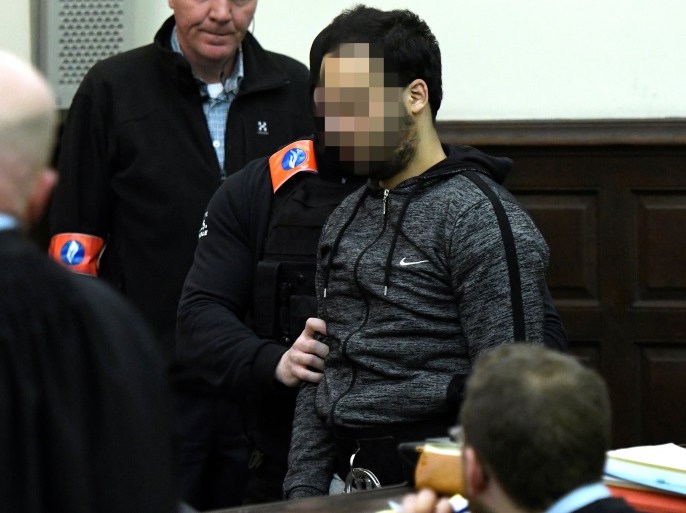 Sofien Ayari is escorted by Belgian police officers as he sits in a courtroom on the second day of the trial of Salah Abdeslam and Ayari at Brussels Palace of Justice, Belgium February 8, 2018. REUTERS/Didier Lebrun/Pool ATTENTION EDITORS - THE DEFENDANT'S FACE HAS BEEN PIXELATED BY JUDICIAL ORDER.