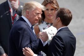 French President Emmanuel Macron shakes hands with U.S. President Donald Trump as First Lady Melania Trump looks on after the traditional Bastille Day military parade in Paris, France, July 14, 2017. REUTERS/Yves Herman