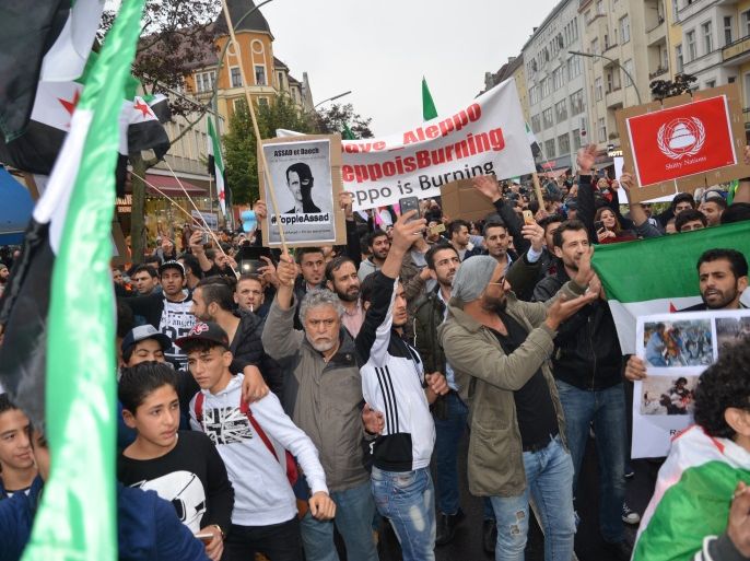 متظاهرون سوريون في برلين يرفعون لافتات تطالب بجلب الأسد لمحكمة الجنايات الدولية. الجزيرة نت.jpg