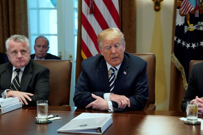U.S. President Donald Trump, flanked by Deputy Secretary of State John Sullivan (L) and Deputy Secretary of Defense Patrick Shanahan (R), holds a cabinet meeting at the White House in Washington, U.S. May 9, 2018. REUTERS/Jonathan Ernst