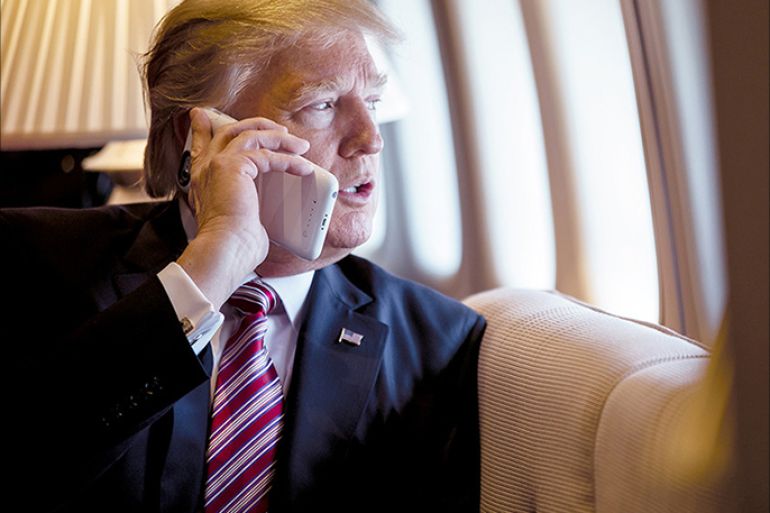 President Donald Trump talks on the phone aboard Air Force One during a flight to Philadelphia on Jan. 26, 2017. | Shealah Craighead/Official White House Photo