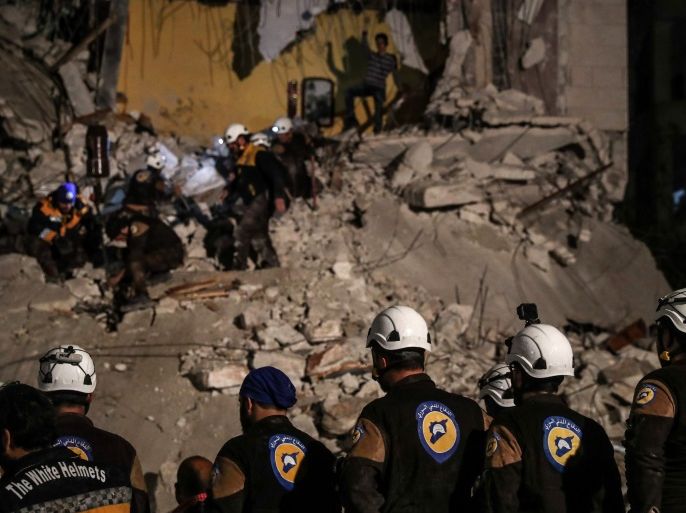 Volunteers of White Helmets search for survivors after an explosion in the city of Idlib, Syria, 09 April 2018