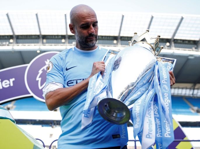 Soccer Football - Premier League - Manchester City vs Huddersfield Town - Etihad Stadium, Manchester, Britain - May 6, 2018 Manchester City manager Pep Guardiola celebrates with the trophy after winning the Premier League title Action Images via Reuters/Carl Recine EDITORIAL USE ONLY. No use with unauthorized audio, video, data, fixture lists, club/league logos or