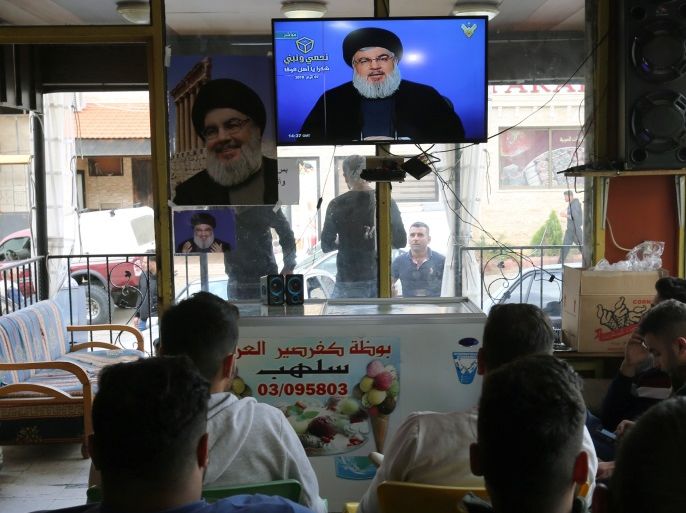 People watch Lebanon's Hezbollah leader Sayyed Hassan Nasrallah speak on television in Marjayoun, Lebanon May 7, 2018. REUTERS/Aziz Taher