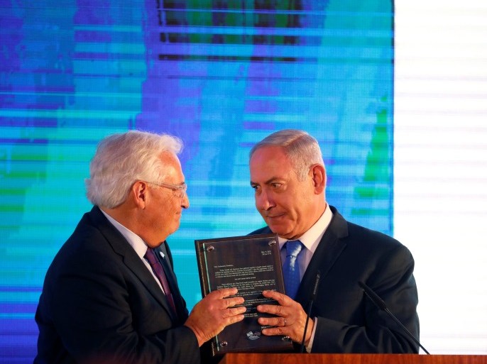 Israeli Prime Minister Benjamin Netanyahu hands U.S. Ambassador to Israel David Friedman a letter of appreciation, during a reception held at the Israeli Ministry of Foreign Affairs in Jerusalem, ahead of the moving of the U.S. embassy to Jerusalem, May 13, 2018. REUTERS/Amir Cohen