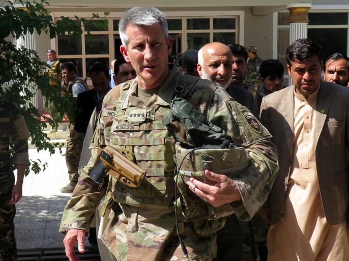 U.S. Army General John Nicholson, commander of Resolute Support forces and U.S. forces in Afghanistan, walks with Afghan officials during an official visit in Farah province, Afghanistan May 19, 2018. Picture taken May 19, 2018. REUTERS/James Mackenzie