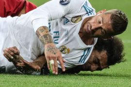 epa06766187 Mohamed Salah (back) of Liverpool and Sergio Ramos of Real Madrid fall during the UEFA Champions League final between Real Madrid and Liverpool FC at the NSC Olimpiyskiy stadium in Kiev, Ukraine, 26 May 2018. The incident let to an injury of Salah who was shortly after taken off the pitch. EPA-EFE/ARMANDO BABANI