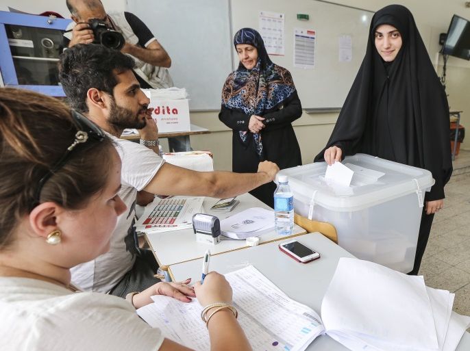 epa06715577 A Lebanese woman supporters of Hezbollah casts her vote at a ballot station in Cheyah area, southern Beirut, Lebanon, 06 May 2018. There are 976 candidates, including 111 women, competing for 128 seats in parliament divided equally between the Muslim and Christian sects, during the general parliamentary elections after nine years of forced extension, through a new electoral law that adopts the percentage. EPA-EFE/NABIL MOUNZER