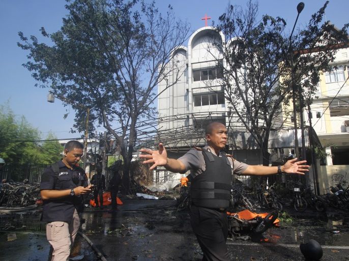 Police stand guard near the site of a blast at the Pentecost Church Central Surabaya (GPPS), in Surabaya, East Java, Indonesia May 13, 2018 in this photo taken by Antara Foto. Antara Foto/Moch Asim / via REUTERS ATTENTION EDITORS - THIS IMAGE WAS PROVIDED BY A THIRD PARTY. MANDATORY CREDIT. INDONESIA OUT.