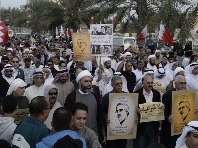 Protesters holding pictures of Al Waad President Ebrahim Shareef march during an anti-government rally organised by Bahrain's main opposition party, Al Wefaq in Budaiya west of Manama, December 26, 2014. Thousands of protesters took part in the rally shouting anti-government slogans and asking for the release of political prisoners. REUTERS/Stringer (BAHRAIN - Tags: POLITICS CIVIL UNREST)