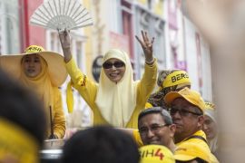 KUALA LUMPUR, MALAYSIA - AUGUST 29: Wan Azizah Wan Ismail, wife of Anwar Ibrahim, gestures to supporters during the Bersih 4.0 rally on August 29, 2015 in Kuala Lumpur, Malaysia. Prime Minister Najib Razak has become embroiled in a scandal involving state fund debts and allegations of deposits totaling 2.6 billion ringgit paid to his bank account. Razak has denied any wrongdoing. Thousand of people gathered to demand his resignation and a new general election. (Photo by Charles Pertwee/Getty Images)