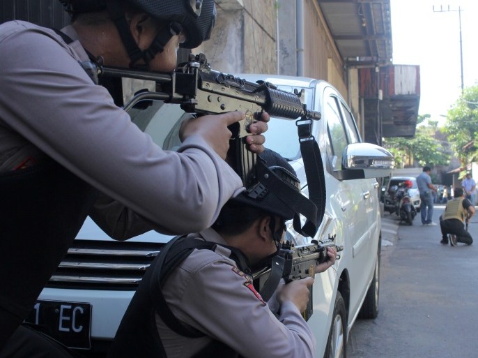 Police aim their weapons at a man who was being searched by other police officers following an explosion at nearby police headquarters in Surabaya, Indonesia May 14, 2018 in this photo taken by Antara Foto. Antara Foto/ Didik Suhartono / via REUTERS ATTENTION EDITORS - THIS IMAGE WAS PROVIDED BY A THIRD PARTY. MANDATORY CREDIT. INDONESIA OUT. TPX IMAGES OF THE DAY