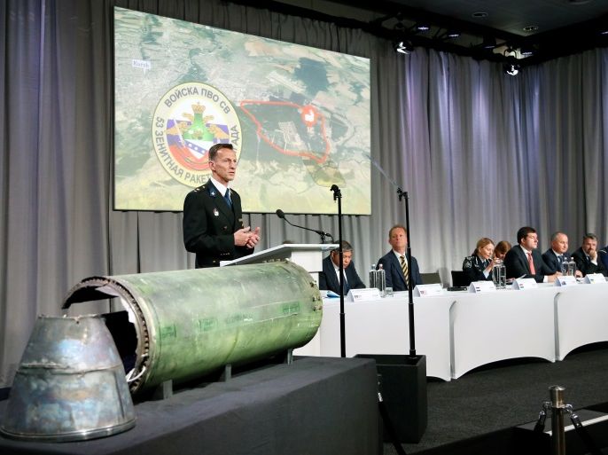 Dutch police officer Wilbert Paulissen, head of the National Crime Squad, is pictured next to a damaged missile as he presents interim results in the ongoing investigation of the 2014 MH17 crash that killed 298 people over eastern Ukraine, during a news conference by members of the Joint Investigation Team, comprising the authorities from Australia, Belgium, Malaysia, the Netherlands and Ukraine, in Bunnik, Netherlands, May 24, 2018. REUTERS/Francois Lenoir
