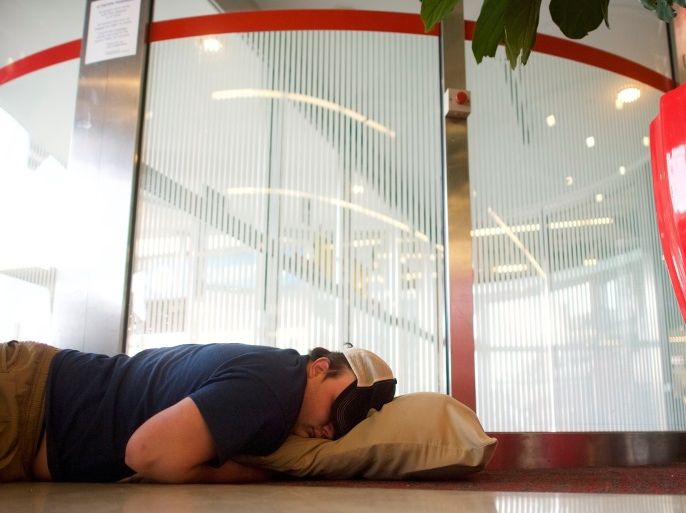A man sleeps on the floor in the Philadelphia International Airport in Philadelphia, Pennsylvania U.S. April 17, 2018. REUTERS/Mark Makela