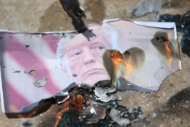 Palestinians burn a picture of President Donald Trump during a sit-in inside the Ain el-Hilweh refugee camp near Sidon, southern Lebanon, May 14, 2018. REUTERS/Ali Hashisho