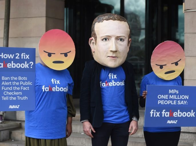 epa06693776 A protester wearing a mask depicting Facebook's CEO, Mark Zuckerberg, flanked by two protesters wearing angry emoji masks protest outside Portcullis House in central London, Britain, 26 April 2018. Facebook’s CTO Mike Schroepfer's is scheduled to appear at Portcullis House infront of British Members of Parliament on the Digital, Culture, Media and Sport Select Committee in the wake of allegations that information on millions of its users was misused. EPA-E