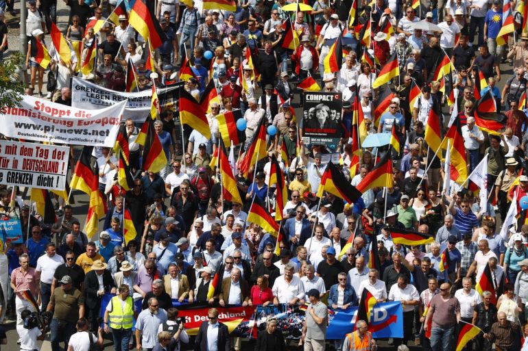 Supporters of the Anti-immigration party Alternative for Germany (AfD) hold German flags during a protest in Berlin, Germany May 27, 2018. REUTERS/Hannibal Hanschke