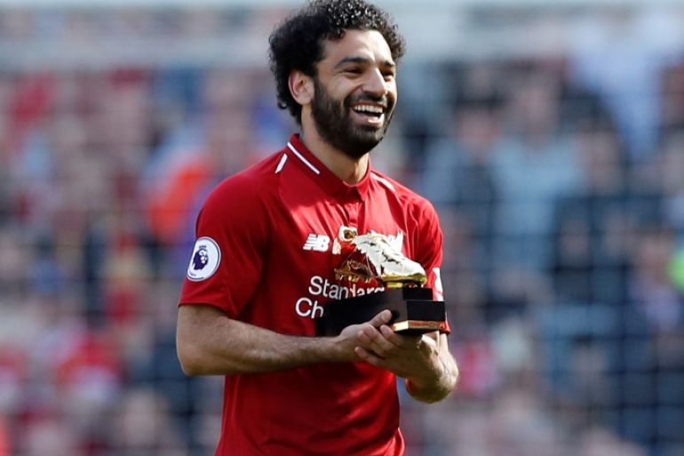 Soccer Football - Premier League - Liverpool vs Brighton &amp; Hove Albion - Anfield, Liverpool, Britain - May 13, 2018 Liverpool's Mohamed Salah celebrates with the Golden Boot after the match Action Images via Reuters/Carl Recine EDITORIAL USE ONLY. No use with unauthorized audio, video, data, fixture lists, club/league logos or