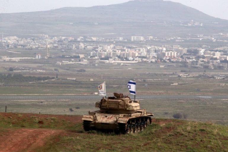 An old military vehicle can be seen positioned on the Israeli side of the border with Syria, near the Druze village of Majdal Shams in the Israeli-occupied Golan Heights, Israel February 11, 2018. REUTERS/Ammar Awad
