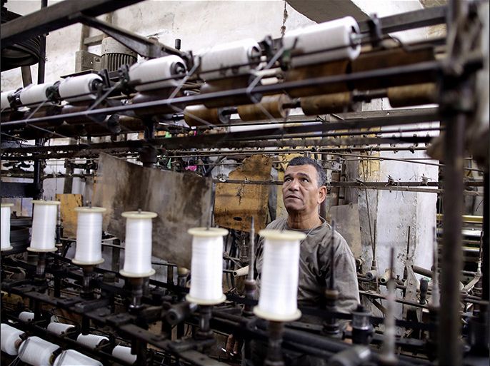 epa06313805 An Egyptian worker prepares textile spinning machine at workshop in Cairo, Egypt, 06 November 2017 (issued 07 November 2017). The workshop supplies yarn to Salama's tannery. Salama started working when he was seven years old during the reign of King Farouk over Egypt because, according to him, the police used to arrest unemployed males of all ages. Now, after almost 70 years, Salama's tannery is the only one left in the old part of Cairo. The yarn produced is used for shoe laces, mattresses upholstery, ballet dance outfits, and suits. EPA-EFE/KHALED ELFIQI