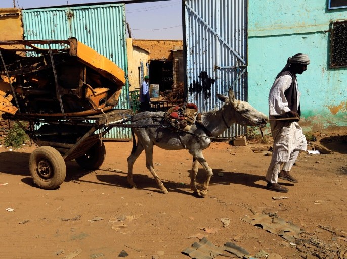 A man walks with remains of a car at an industrial area in Khartoum, Sudan November 3, 2016. REUTERS/Mohamed Nureldin Abdallah.