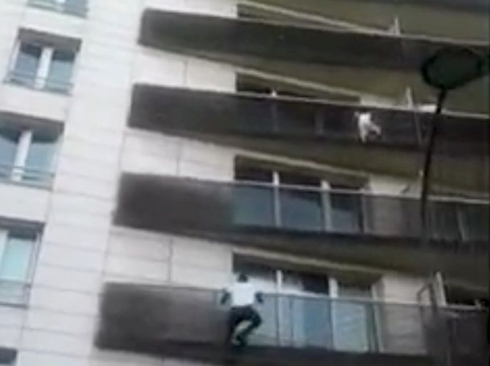 Mali immigrant rescues dangling child from balcony in Paris, France, in this May 26, 2018 still image obtained May 28, 2018 from social media video. TAREK DANDACH/via REUTERS ATTENTION EDITORS - THIS IMAGE HAS BEEN SUPPLIED BY A THIRD PARTY. MANDATORY CREDIT.