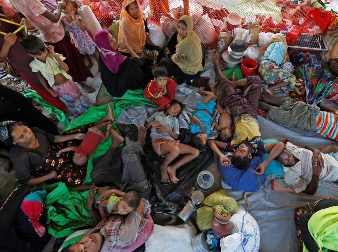Rohingya refugees who crossed the border from Myanmar this week take shelter under a tent along a roadside at Kutupalong refugee camp near Cox's Bazar, Bangladesh October 28, 2017. REUTERS/Adnan Abidi TEMPLATE OUT