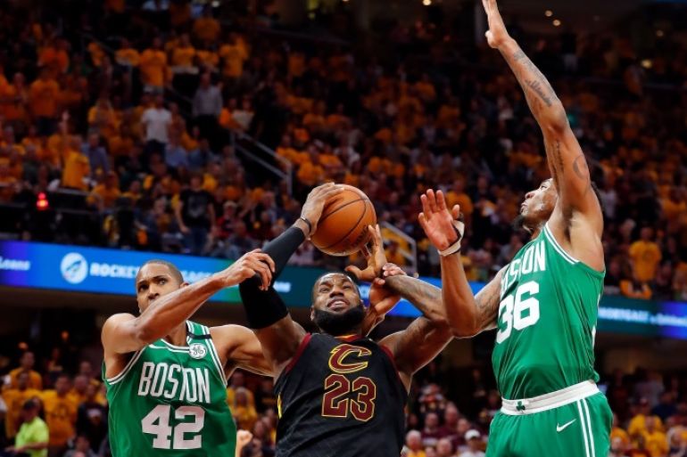 May 19, 2018; Cleveland, OH, USA; Cleveland Cavaliers forward LeBron James (23) is fouled by Boston Celtics forward Al Horford (42) in front of guard Marcus Smart (36) during the first half in game three of the Eastern conference finals of the 2018 NBA Playoffs at Quicken Loans Arena. Mandatory Credit: Rick Osentoski-USA TODAY Sports