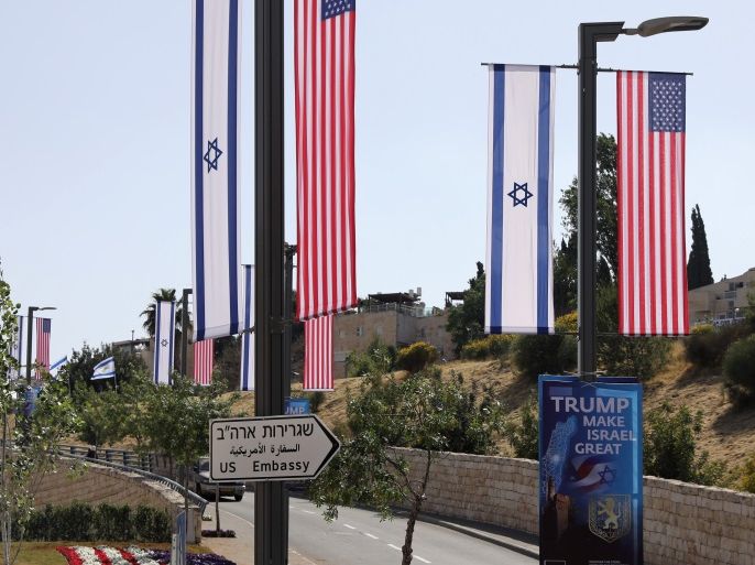 A woman walks next to a road sign directing to the U.S. embassy, in the area of the U.S. consulate in Jerusalem, May 11, 2018. REUTERS/Ammar Awad