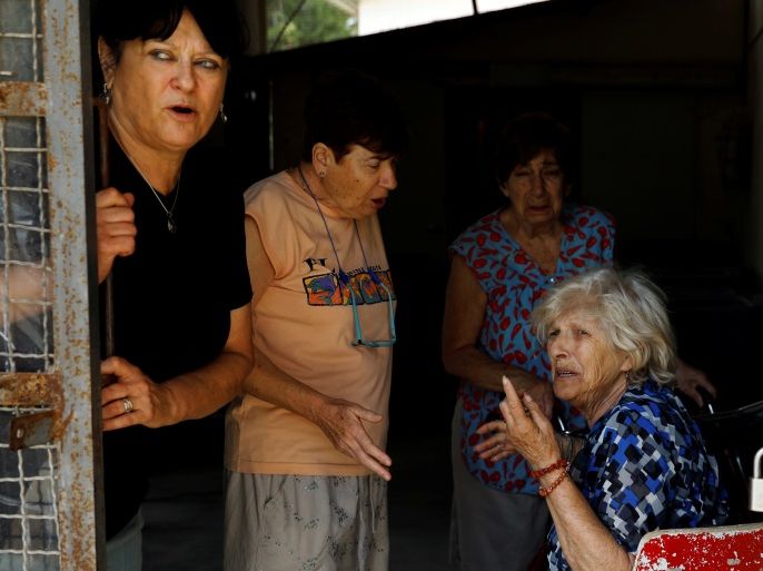 Women react after a siren is sounded, in a Kibbutz on the Israeli side of the Israeli-Gaza border, May 29, 2018. REUTERS/Amir Cohen