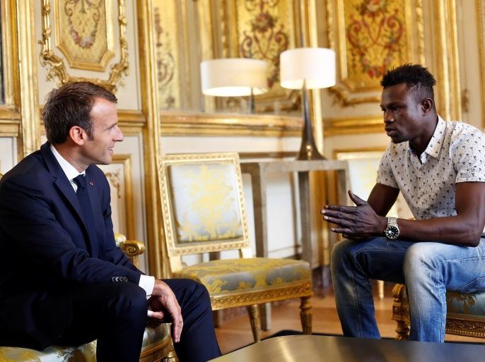 French President Emmanuel Macron (L) meets with Mamoudou Gassama, 22, from Mali, at the Elysee Palace in Paris, France, May 28, 2018. Mamoudou Gassama living illegally in France is being honored by Macron for scaling an apartment building over the weekend to save a 4-year-old child dangling from a fifth-floor balcony. Thibault Camus/Pool via Reuters
