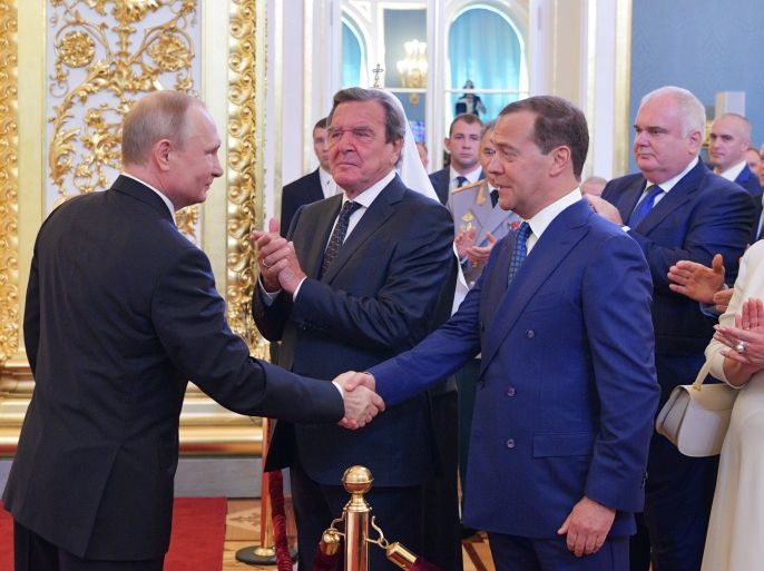 Russian Prime Minister Dmitry Medvedev (3rd L) and German former Chancellor Gerhard Schroeder (2nd L) greet Vladimir Putin (L), who is sworn as Russian President during an inauguration ceremony at the Kremlin in Moscow, Russia May 7, 2018. Sputnik/Alexei Druzhinin/Kremlin via REUTERS ATTENTION EDITORS - THIS IMAGE WAS PROVIDED BY A THIRD PARTY.