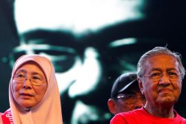 Former Malaysian prime minister Mahathir Mohamad (R) and opposition leaders Wan Azizah look on as a video clip of Anwar Ibrahim is being played during an anti-kleptocracy rally in Petaling Jaya, near Kuala Lumpur, Malaysia October 14, 2017. REUTERS/Lai Seng Sin
