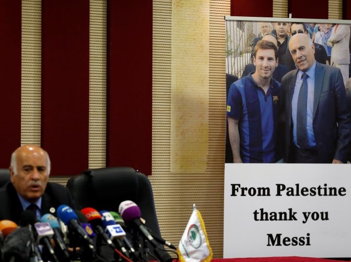 A poster of Palestinian FA chief Jibril Rajoub with Argentina's soccer player Lionel Messi is seen during Rajoub's news conference, in Ramallah in the occupied West Bank June 6, 2018. REUTERS/Mohamad Torokman