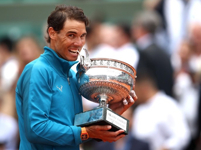 PARIS, FRANCE - JUNE 10: Rafael Nadal of Spain holds the Musketeers' Cup as he celebrates victory following the mens singles final against Dominic Thiem of Austria during day fifteen of the 2018 French Open at Roland Garros on June 10, 2018 in Paris, France. (Photo by Cameron Spencer/Getty Images)