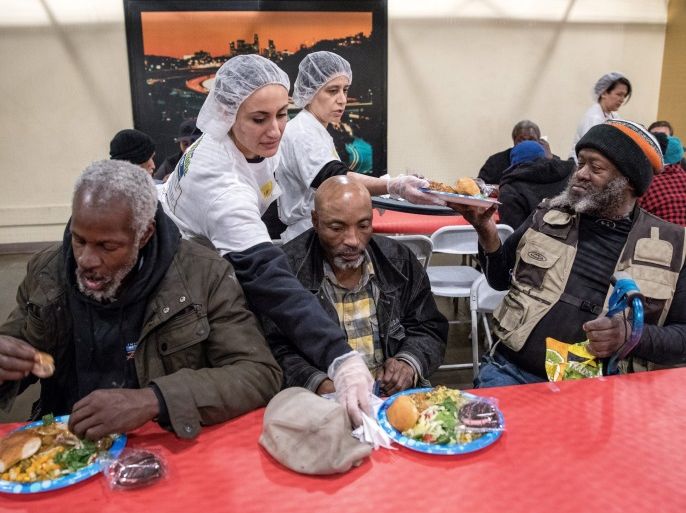 Iranian-American volunteers cook and serve food for homeless and near-homeless people at Midnight Mission shelter on Skid Row to celebrate Nowruz, Iranian New Year in Los Angeles, California, U.S. March 16, 2018. REUTERS/Monica Almeida